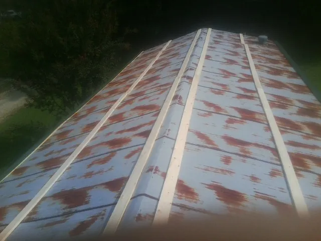 Rusted metal roof panels with new wood purlins before replacement — Storm Damage Roof Repair in Deep Run by Roofing Brothers