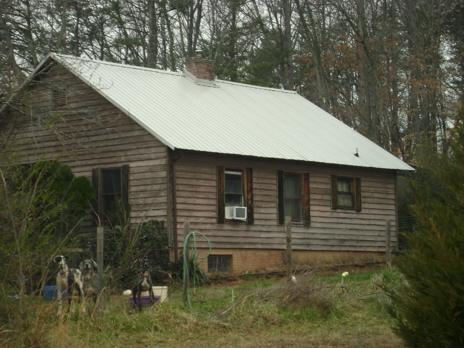 White metal roof on an old wood sided farmhouse, from a Metal Roof Installation job in Deep Run
